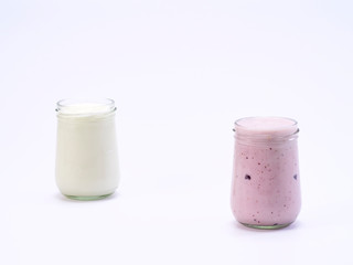Fresh blueberry yogurt glass on a white background