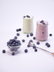 Fresh blueberry yogurt glass on a white background