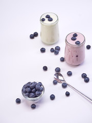 Fresh blueberry yogurt glass on a white background