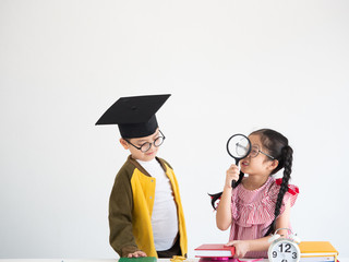 back to school concept , Asian boy and girl with books and clock on the desk white background