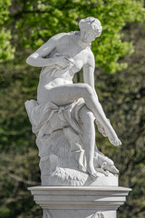 Old statue of a sensual Renaissance era woman after bathing in a park of Potsdam, Germany, details, closeup
