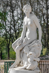 Old statue of a sensual Renaissance era woman after bathing in a park of Potsdam, Germany, details, closeup