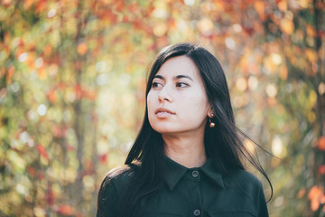 Female beauty portrait surrounded by vivid foliage. Dreamy beautiful girl with long natural black...