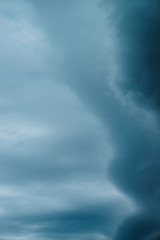 Obraz premium Dramatic cloudscape texture. Dark heavy thunderstorm clouds before rain. Overcast rainy bad weather. Storm warning. Natural blue background of cumulonimbus. Nature backdrop of stormy cloudy sky.