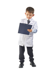 Little boy wearing lab coat making notes in clipboard on white background