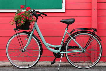 Fototapeta na wymiar bicycle on a wooden red house background