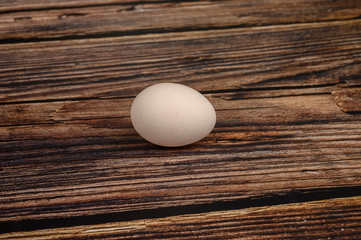 Chicken egg on wooden table background. close up