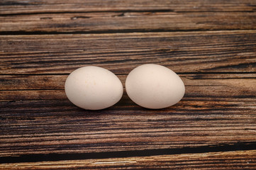 Chicken egg on wooden table background. close up