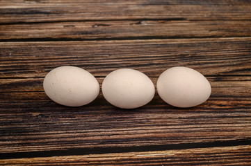 Chicken egg on wooden table background. close up