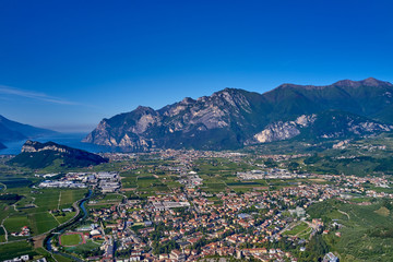 Aerial view of Lake Garda, mountains, cliffs and the city of Riva del Garda, Italy.