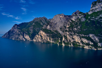 Aerial view of Lake Garda, mountains, cliffs and the city of Riva del Garda, Italy.