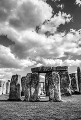 Detail of Stonehenge Monoliths under the sun, blue sky with clouds, England, UK