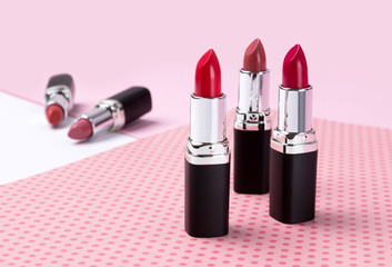 Fashion Trendy Colorful Lipsticks over pink background.