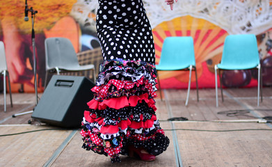 The woman dances flamenco outdoors
