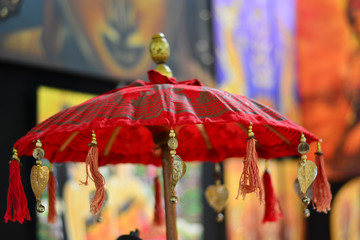 a colorful red umbrella against the sun