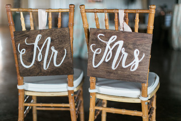 mr and mrs wooden signs on back of chair, wedding reception decor - Powered by Adobe