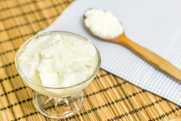Natural homemade plain organic yogurt with wood spoon 