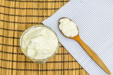 Natural homemade plain organic yogurt with wood spoon 