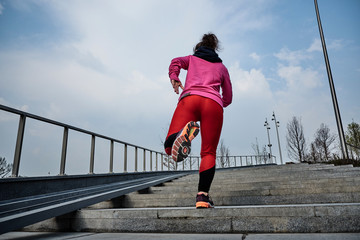 Fototapeta na wymiar healthy lifestyle sports woman running up on stone stairs at sunrise seaside