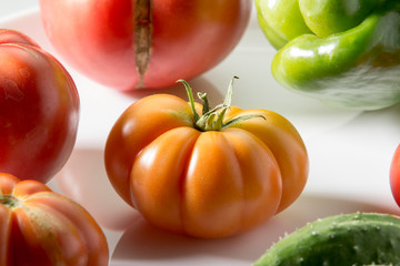 Ugly freak organic tomato and cucumber and pepper on a white background. The concept of organic...