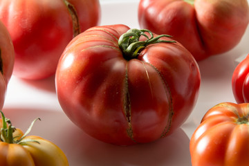 Ugly freak organic tomato on a white background. The concept of organic vegetables.