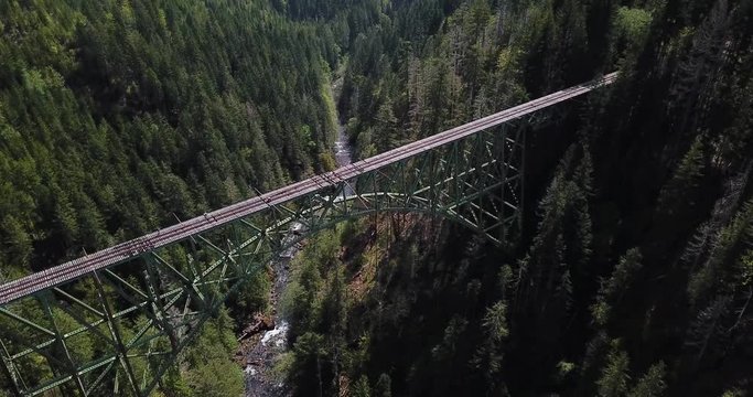 Spectacular Cinematic Aerial of Massive Abandoned Vance Creek Bridge Over Deep Canyon and Evergreen Forest
