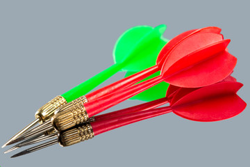 Red and green darts on a mirror background. Hit the target