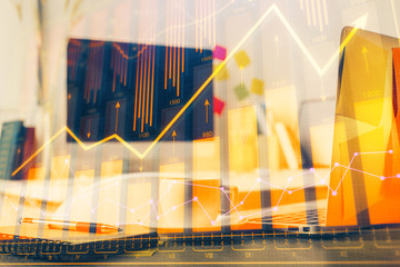 Financial chart drawing and table with computer on background. Multi exposure. Concept of international markets.