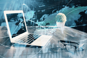 Double exposure of chart and financial info and work space with computer background. Concept of international online trading.