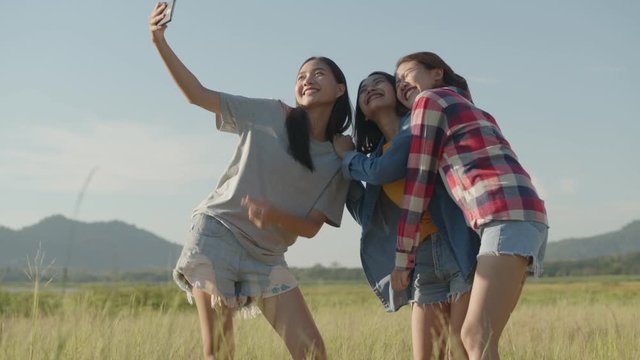 Attractive three young people, Asian women taking selfies having fun together a summer traveling. Lifestyle travel holiday vacation time. Having a mountain background.