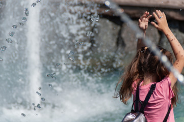 Fountain. Girl in pink.