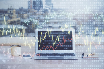 Financial graph colorful drawing and table with computer on background. Multi exposure. Concept of...
