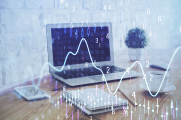 Stock market chart hologram drawn on personal computer background. Multi exposure. Concept of investment.