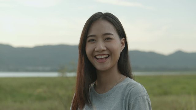 Dolly zoom portrait of beautiful young Asian woman smiling look at camera enjoying having fun together a summer traveling. Asian friends' lifestyle travels holiday vacation time.