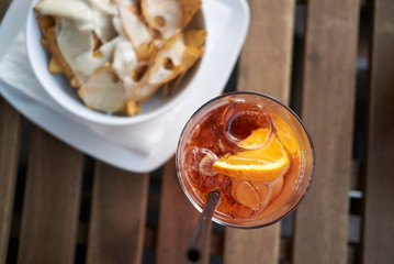 Spritz cocktail with nachos chips