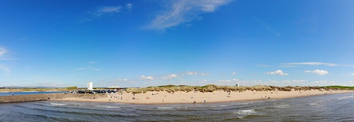 Panoramic image of a busy beach 