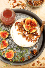 Healthy breakfast with cottage cheese, granola and figs 