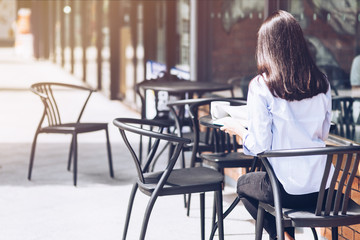 Working in the morning. Cheerful girl working outdoors. Concept of female freelancer business. Copy space on the left side