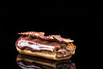 French Artisan Eclair on Black Reflective Background,Copy Space