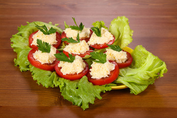 Tomato slices with cheese served parsley