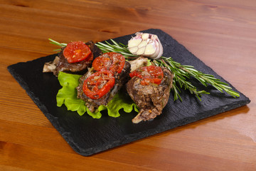 Baked elk meat with tomatoes