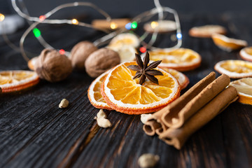 Anise and dried orange slices on a background of wood