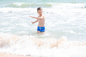 little boy and the sea waves