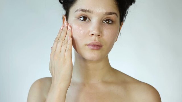 Beautiful young Girl Applying aloe vera gel on her face. Facial Hydrogel. Skin care