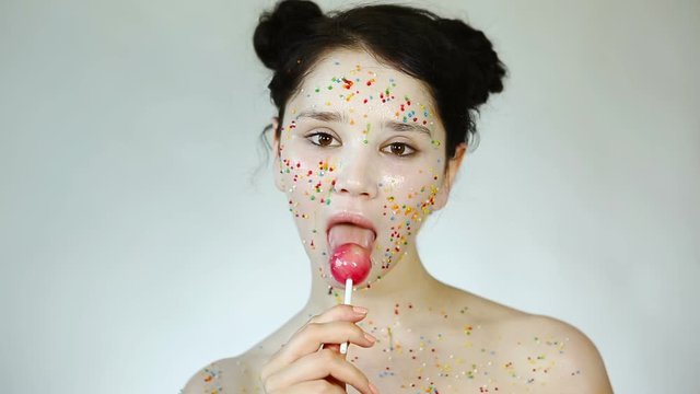 Beauty Portrait close up with baby face makeup and Candy. Portrait of a young pretty girl