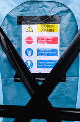 Warning signs at the entrance to an Asbestos clean-up