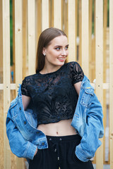 Beautiful model in denim jacket fashionable clothes in the city park.