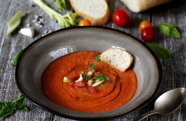 gazpacho with bread. cold soup made of tomatoes and watermelon - salmorejo . Spanish cuisine. soup with bread, butter, celery, cucumber. paleo diet. Orange color.