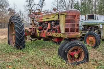 Farm tractor abandoned in field