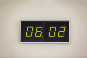 Black digital clock on a white background showing time 06.02 minutes